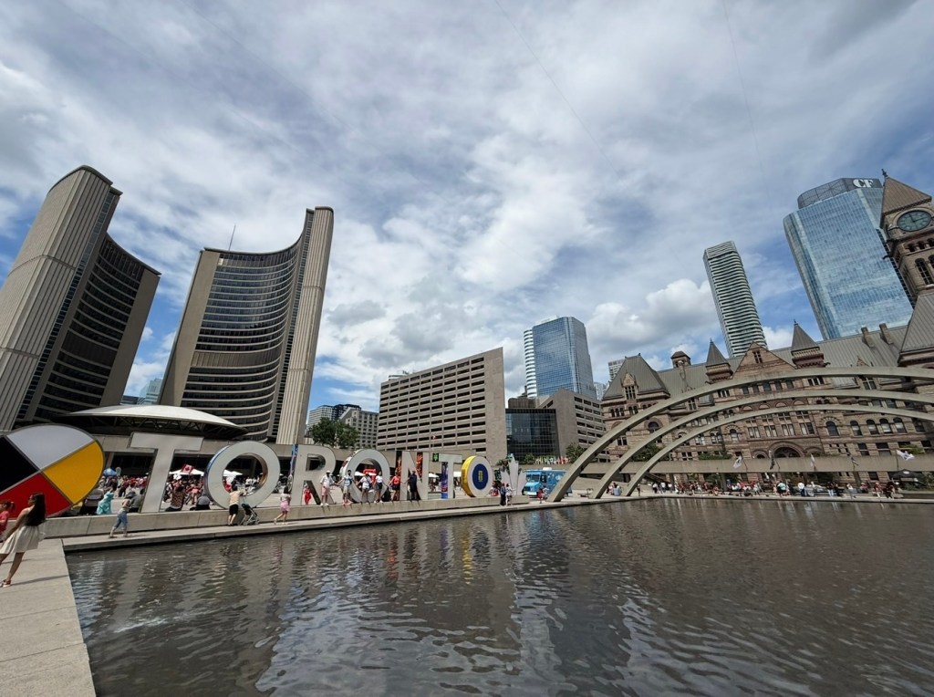 Toronto sign and city hall at Nathan Phillips Square Canada